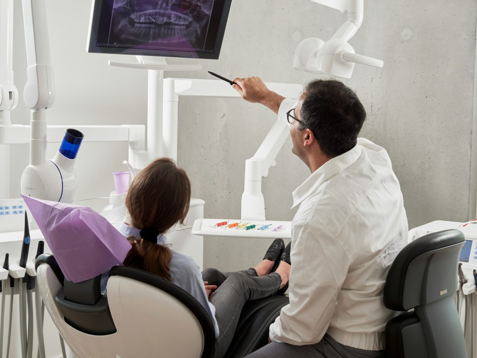 Dentist treating a patient in the chair